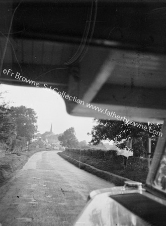 THROUGH WINDSCREEN APPROACHING VILLAGE